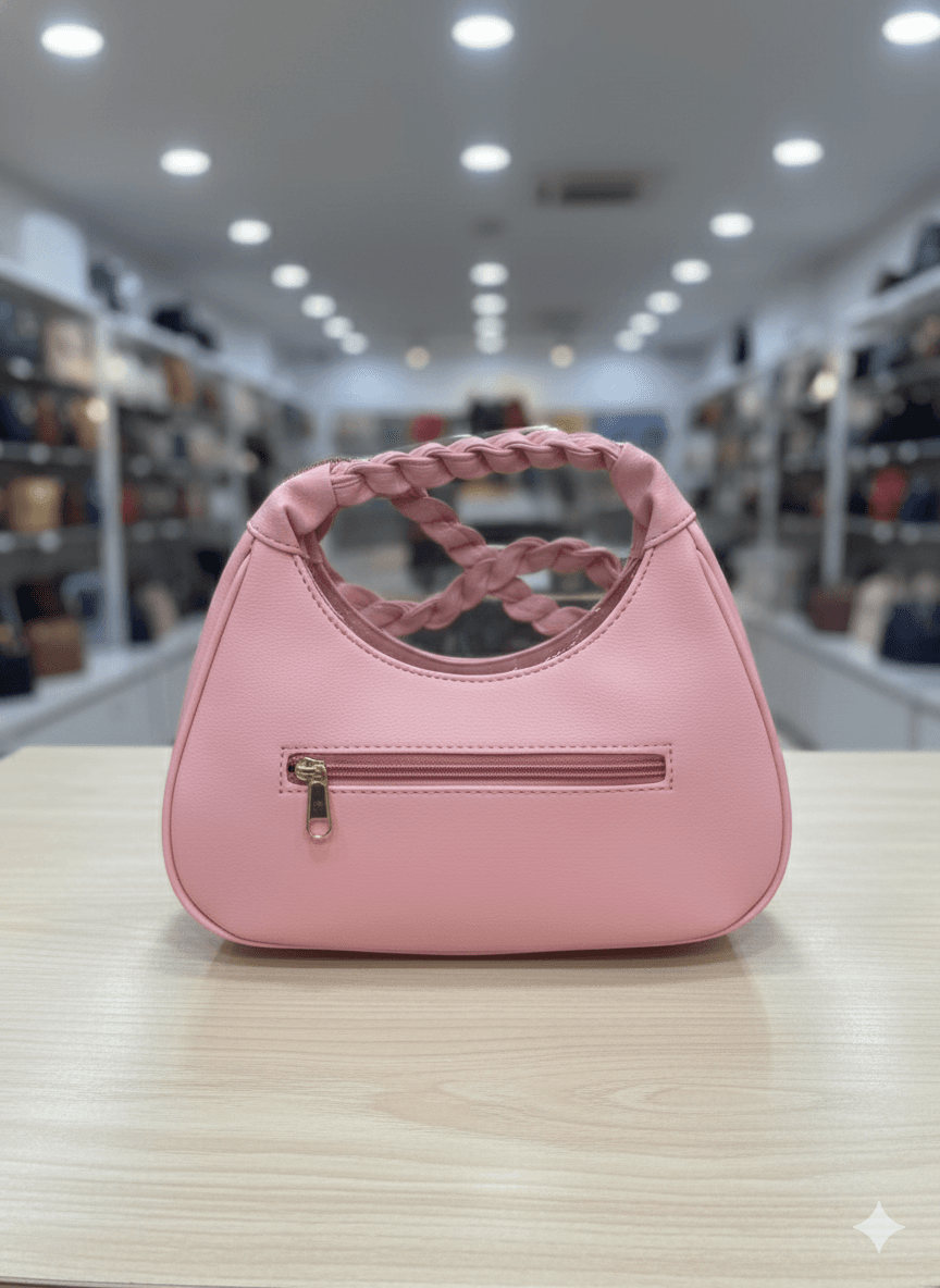 pink shoulder bag with a braided top handle and a decorative bow 1